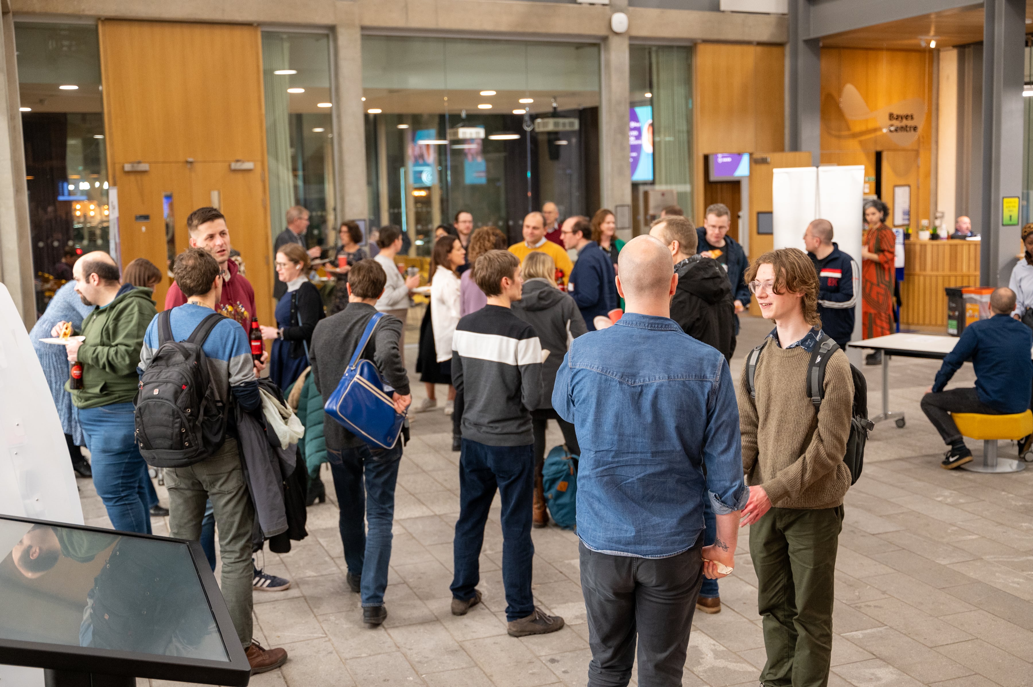 A group of people standing around at a Data Lab Community event 